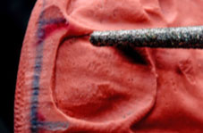 Marking out the final shape on the impression, guides modification using the burr